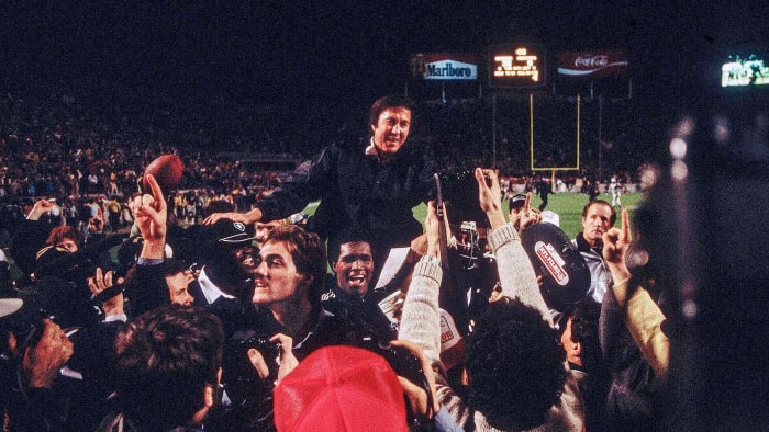 Tom Flores is carried off the field after Super Bowl XVIII